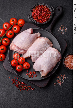 Raw chicken thighs with salt, spices and herbs Raw chicken thighs with salt, spices and herbs 122275761