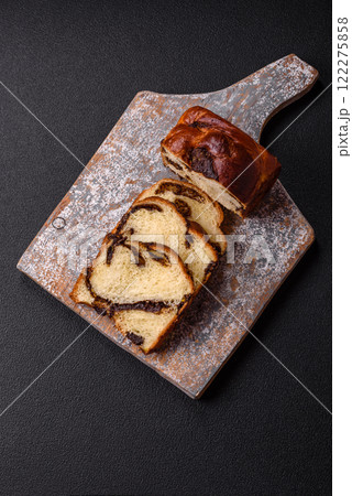Sweet poppy seed cake on a dark concrete background 122275858