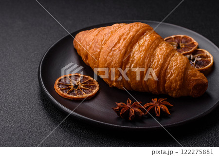 Golden crispy croissant with a sweet creamy fruit filling Golden crispy croissant with a sweet creamy fruit filling 122275881