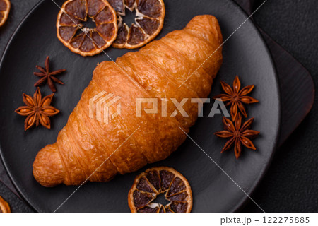 Golden crispy croissant with a sweet creamy fruit filling 122275885