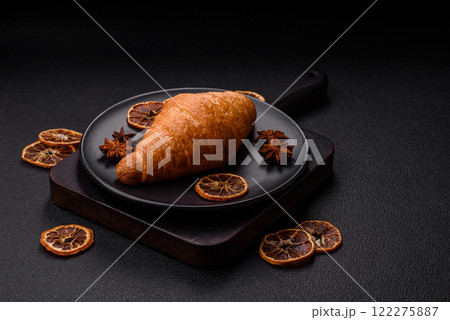 Golden crispy croissant with a sweet creamy fruit filling 122275887