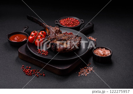 Grilled wagyu beef tomahawk steak with salt, spices and herbs Grilled wagyu beef tomahawk steak with salt, spices and herbs 122275957