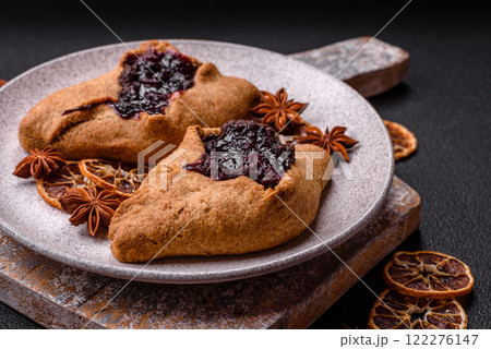 Sweet rye pies with cherries and chocolate Sweet rye pies with cherries and chocolate 122276147