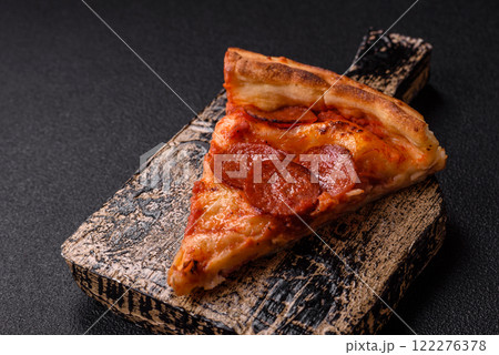 Pepperoni pizza with sausage, mozzarella cheese, tomatoes, salt and spices 122276378