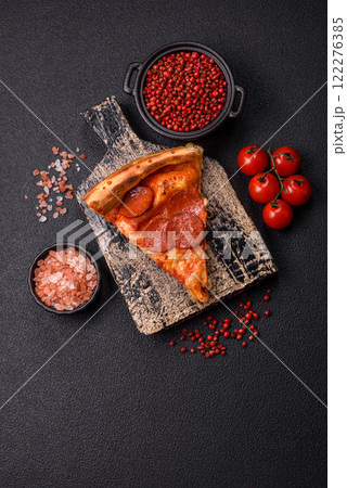 Pepperoni pizza with sausage, mozzarella cheese, tomatoes, salt and spices 122276385