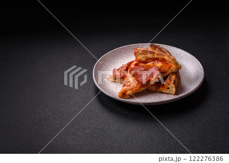 Pepperoni pizza with sausage, mozzarella cheese, tomatoes, salt and spices Pepperoni pizza with sausage, mozzarella cheese, tomatoes, salt and spices 122276386