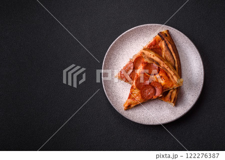 Pepperoni pizza with sausage, mozzarella cheese, tomatoes, salt and spices Pepperoni pizza with sausage, mozzarella cheese, tomatoes, salt and spices 122276387