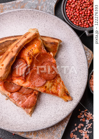 Pepperoni pizza with sausage, mozzarella cheese, tomatoes, salt and spices Pepperoni pizza with sausage, mozzarella cheese, tomatoes, salt and spices 122276393