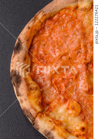 Pizza margherita with cheese, tomatoes, salt, spices and herbs Pizza margherita with cheese, tomatoes, salt, spices and herbs 122276421