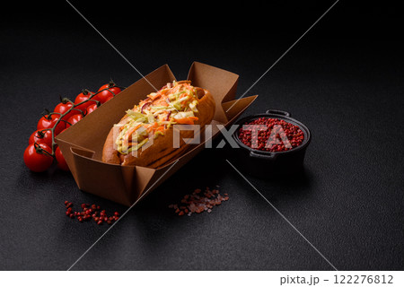 Hotdog with grilled sausage with cabbage, carrots and onions Hotdog with grilled sausage with cabbage, carrots and onions 122276812