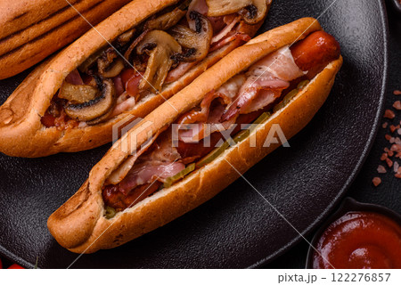 Hotdog with grilled sausage with bacon and mushrooms Hotdog with grilled sausage with bacon and mushrooms 122276857
