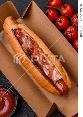 Hotdog with grilled sausage with bacon and mushrooms 122276910