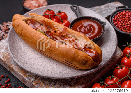 Hotdog with grilled sausage with bacon and mushrooms 122276919
