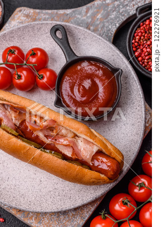 Hotdog with grilled sausage with bacon and mushrooms 122276921