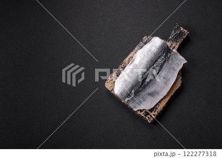 Herring fillet salted and marinated with salt, spices and oil Herring fillet salted and marinated with salt, spices and oil 122277318