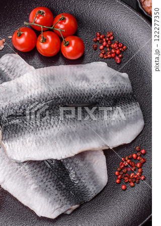 Herring fillet salted and marinated with salt, spices and oil Herring fillet salted and marinated with salt, spices and oil 122277350