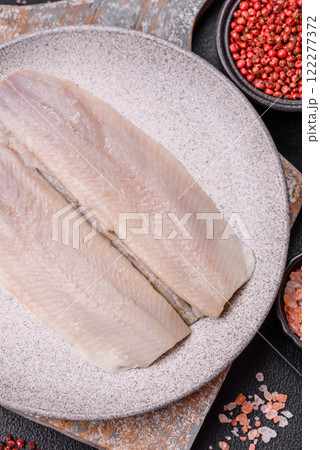 Herring fillet salted and marinated with salt, spices and oil 122277372
