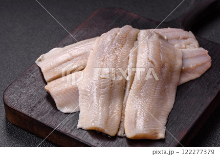 Herring fillet salted and marinated with salt, spices and oil 122277379