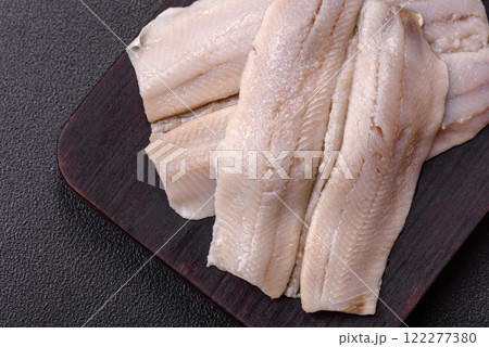 Herring fillet salted and marinated with salt, spices and oil 122277380