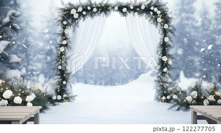 Winter wedding arch decorated with white roses and fairy lights in snowy landscape 122277705
