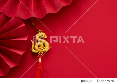 Chinese new Year background. Golden Snake Pendant on Red Chinese new Year background. Golden Snake Pendant on Red 122277970