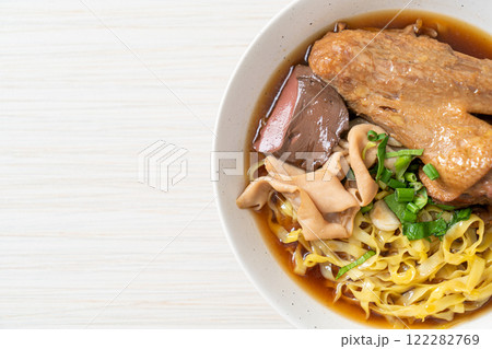 egg noodles with stewed and braised duck in brown soup 122282769