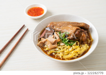 egg noodles with stewed and braised duck in brown soup 122282770