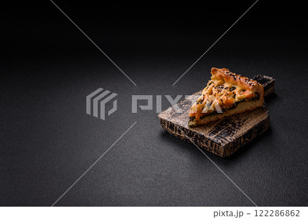 Pieces of quiche with salmon, spinach or broccoli, salt and spices 122286862