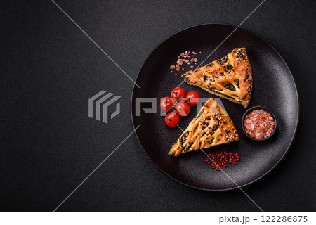 Pieces of quiche with salmon, spinach or broccoli, salt and spices Pieces of quiche with salmon, spinach or broccoli, salt and spices 122286875