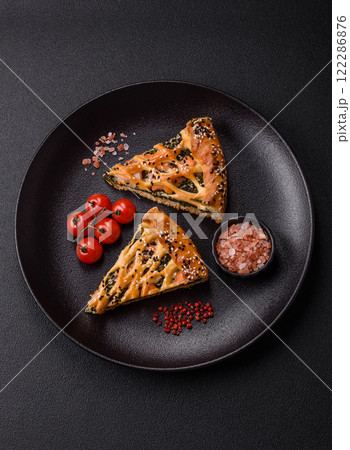 Pieces of quiche with salmon, spinach or broccoli, salt and spices Pieces of quiche with salmon, spinach or broccoli, salt and spices 122286876