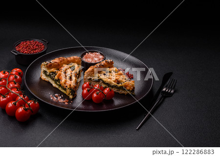 Pieces of quiche with salmon, spinach or broccoli, salt and spices 122286883