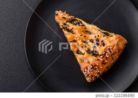 Pieces of quiche with salmon, spinach or broccoli, salt and spices Pieces of quiche with salmon, spinach or broccoli, salt and spices 122286890