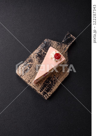 Piece of sweet cake with pink cream with raspberry flavor, with shortbread, cheesecake Piece of sweet cake with pink cream with raspberry flavor, with shortbread, cheesecake 122287343