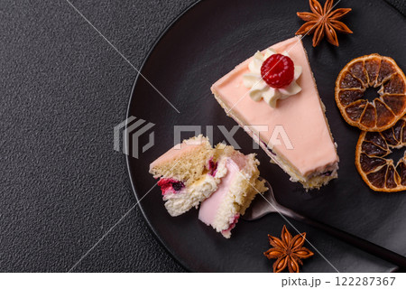 Piece of sweet cake with pink cream with raspberry flavor, with shortbread, cheesecake 122287367
