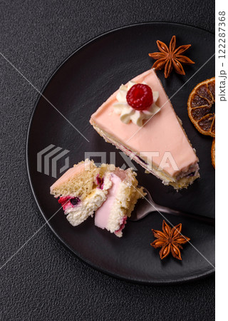 Piece of sweet cake with pink cream with raspberry flavor, with shortbread, cheesecake 122287368