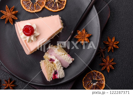 Piece of sweet cake with pink cream with raspberry flavor, with shortbread, cheesecake Piece of sweet cake with pink cream with raspberry flavor, with shortbread, cheesecake 122287371