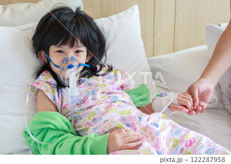 Sick little asian girl inhalation with nebulizer for respiratory treatment Sick little asian girl inhalation with nebulizer for respiratory treatment 122287958