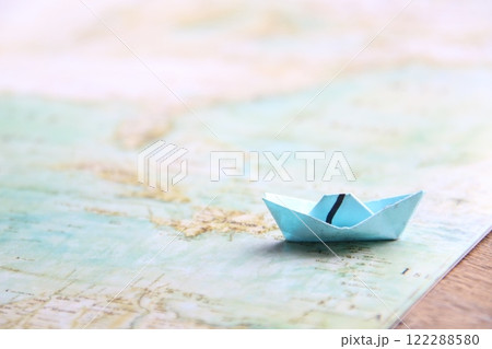 Paper boat on Ancient world map. 122288580