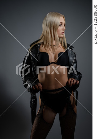 Fashionable model poses confidently in stylish jacket and lingerie set 122288630