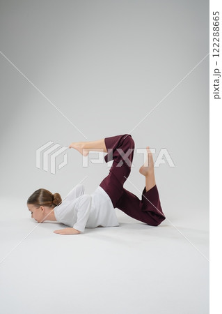 Girl performs an impressive dance pose showcasing athletic skill and artistry 122288665