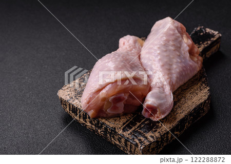 Raw chicken legs with salt, spices, herbs and tomatoes Raw chicken legs with salt, spices, herbs and tomatoes 122288872
