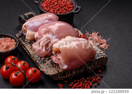 Fresh raw chicken thigh fillets with salt, spices and herbs 122288939