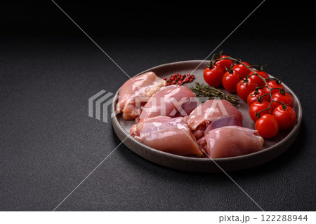 Fresh raw chicken thigh fillets with salt, spices and herbs Fresh raw chicken thigh fillets with salt, spices and herbs 122288944