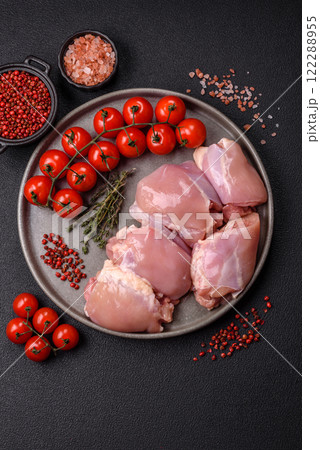 Fresh raw chicken thigh fillets with salt, spices and herbs Fresh raw chicken thigh fillets with salt, spices and herbs 122288955