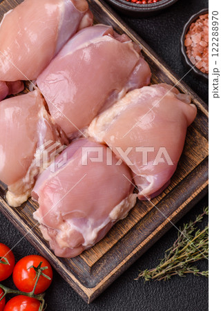 Fresh raw chicken thigh fillets with salt, spices and herbs 122288970