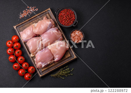 Fresh raw chicken thigh fillets with salt, spices and herbs 122288972
