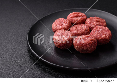 Raw meatballs of minced meat beef, pork or chicken with salt, spices Raw meatballs of minced meat beef, pork or chicken with salt, spices 122289077