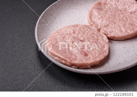 Raw chicken burger cutlet with salt, spices and herbs Raw chicken burger cutlet with salt, spices and herbs 122289101