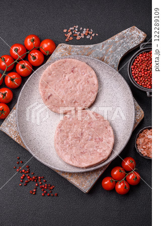 Raw chicken burger cutlet with salt, spices and herbs 122289109
