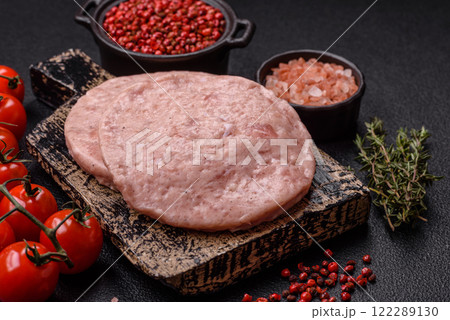 Raw chicken burger cutlet with salt, spices and herbs 122289130